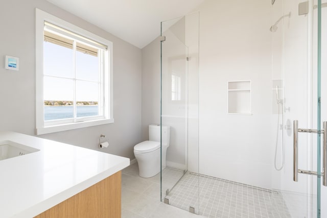 bathroom featuring toilet, vanity, an enclosed shower, and tile patterned flooring