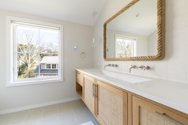 bathroom with lofted ceiling and vanity