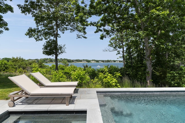 view of swimming pool featuring a water view