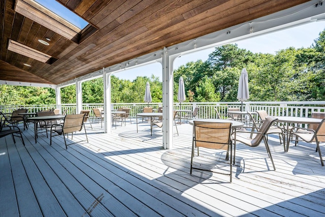 wooden terrace featuring outdoor dining area