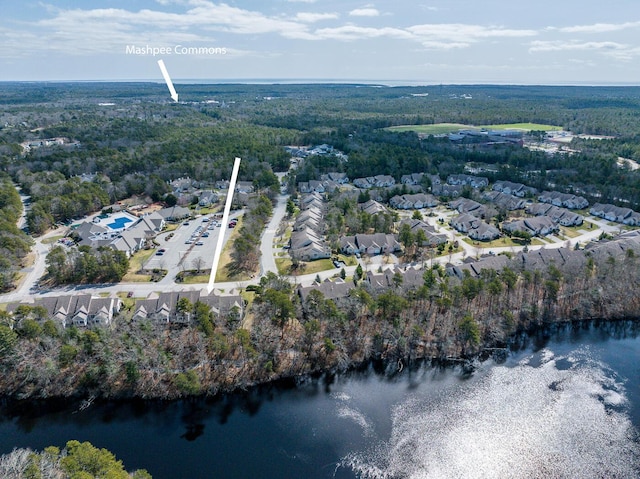 aerial view featuring a residential view, a water view, and a view of trees
