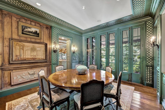 dining space featuring hardwood / wood-style flooring and ornamental molding