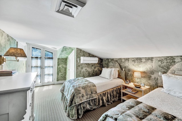 carpeted bedroom with lofted ceiling, access to outside, french doors, and a wall mounted air conditioner