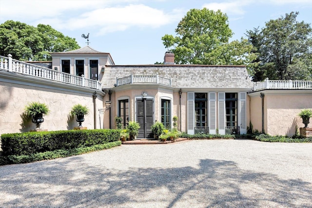 view of front of home featuring a balcony