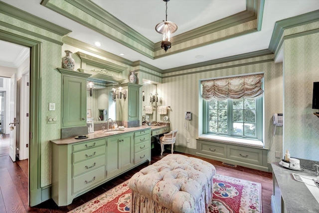 bathroom with crown molding, hardwood / wood-style floors, and a tray ceiling