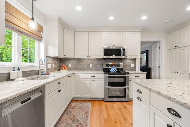 23 Ridgehill Ln, Sagamore Beach, MA 02562 - kitchen featuring appliances with stainless steel finishes, a sink, tasteful backsplash, white cabinets, and recessed lighting