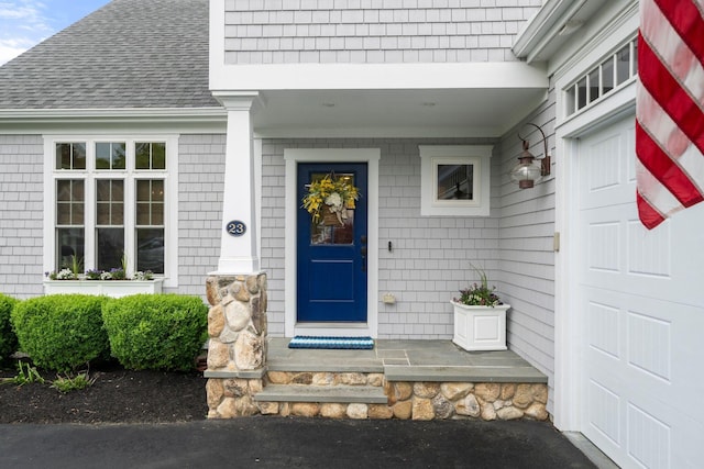 23 Ridgehill Ln, Sagamore Beach, MA 02562 - property entrance with a porch and roof with shingles