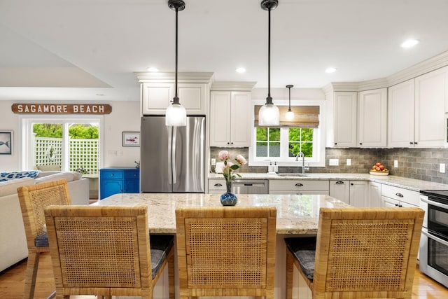 23 Ridgehill Ln, Sagamore Beach, MA 02562 - kitchen featuring stainless steel appliances, plenty of natural light, a sink, white cabinets, and recessed lighting