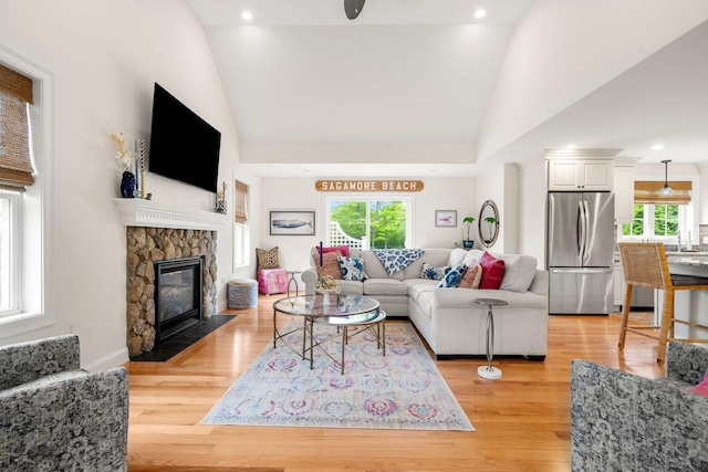 23 Ridgehill Ln, Sagamore Beach, MA 02562 - living area with light wood-style floors, a stone fireplace, high vaulted ceiling, and recessed lighting