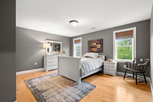 23 Ridgehill Ln, Sagamore Beach, MA 02562 - bedroom featuring multiple windows, baseboards, and light wood-style floors