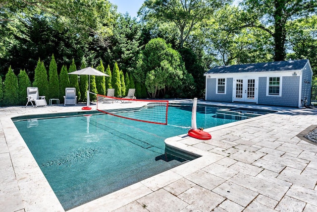 view of pool featuring an outbuilding and a patio