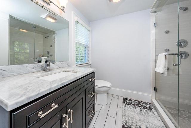 bathroom with vanity, toilet, and walk in shower