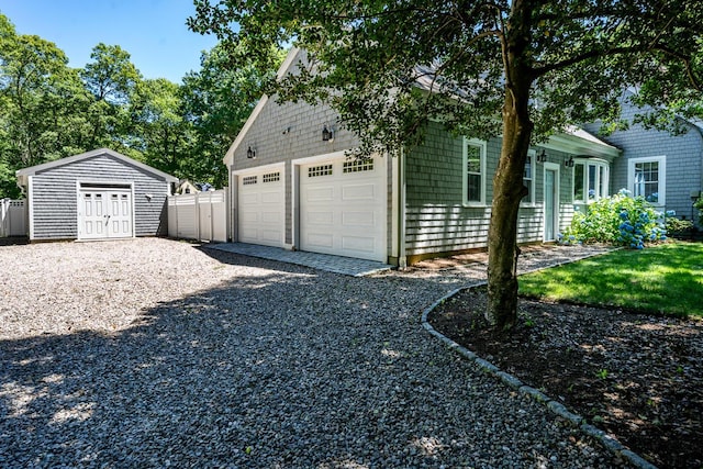 exterior space with a garage and a storage shed