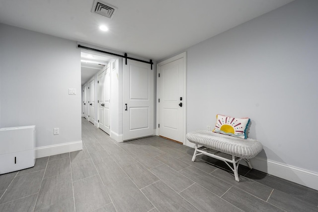 unfurnished room featuring a barn door