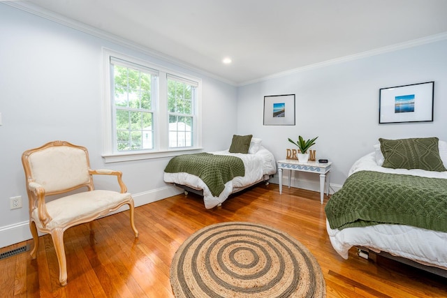 bedroom featuring hardwood / wood-style flooring and ornamental molding