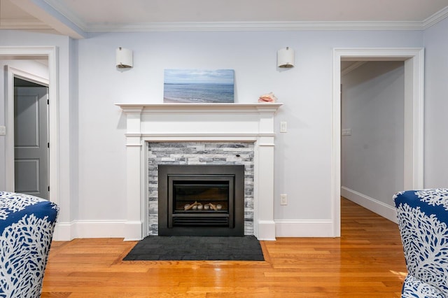 interior details featuring hardwood / wood-style floors, a stone fireplace, and ornamental molding