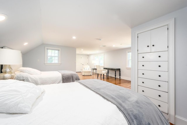 bedroom with hardwood / wood-style flooring and vaulted ceiling