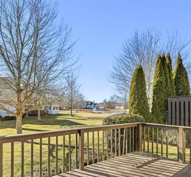 wooden deck featuring a yard