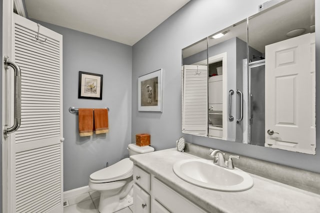 bathroom featuring a shower with door, toilet, tile patterned floors, and vanity