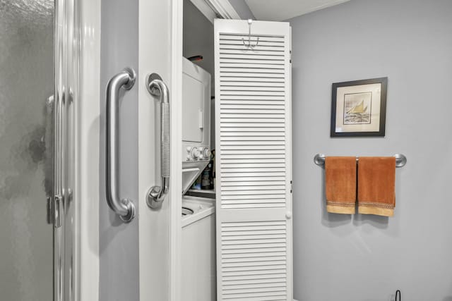 laundry area with stacked washer and clothes dryer