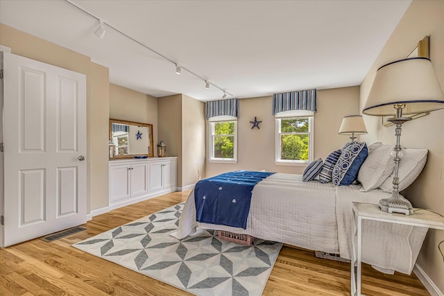 26 Sandy Meadow Way, Eastham, MA 02642 - bedroom featuring track lighting and wood finished floors