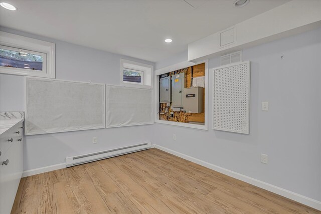 26 Sandy Meadow Way, Eastham, MA 02642 - basement with a baseboard radiator, light wood finished floors, recessed lighting, and electric panel