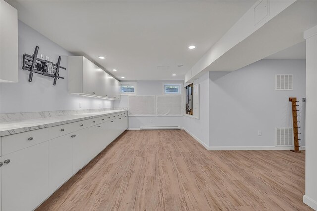 26 Sandy Meadow Way, Eastham, MA 02642 - interior space featuring light wood finished floors, a baseboard radiator, white cabinets, and recessed lighting