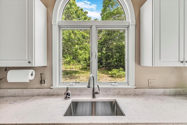 26 Sandy Meadow Way, Eastham, MA 02642 - kitchen featuring light stone counters and white cabinets