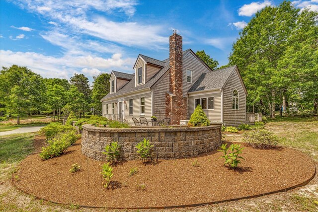 26 Sandy Meadow Way, Eastham, MA 02642 - back of property with a chimney and roof with shingles