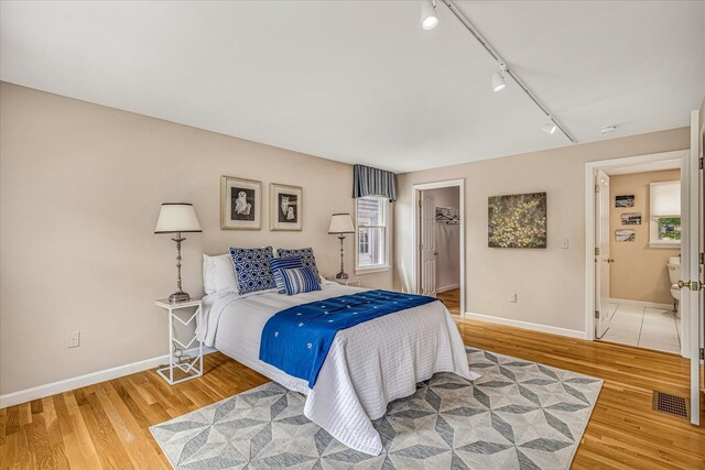 26 Sandy Meadow Way, Eastham, MA 02642 - bedroom featuring rail lighting, light wood-style flooring, a spacious closet, and a closet