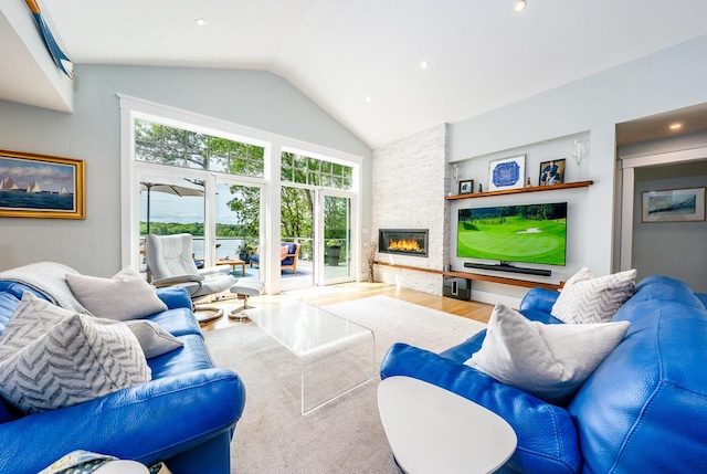 585 Santuit Rd, Cotuit, MA 02635 - living area with a stone fireplace, high vaulted ceiling, wood finished floors, and recessed lighting