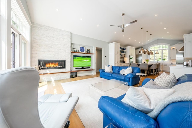 585 Santuit Rd, Cotuit, MA 02635 - living room featuring lofted ceiling, a stone fireplace, light wood finished floors, ceiling fan, and recessed lighting
