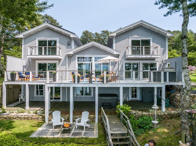 585 Santuit Rd, Cotuit, MA 02635 - rear view of property featuring a patio, a fire pit, a balcony, and a hot tub