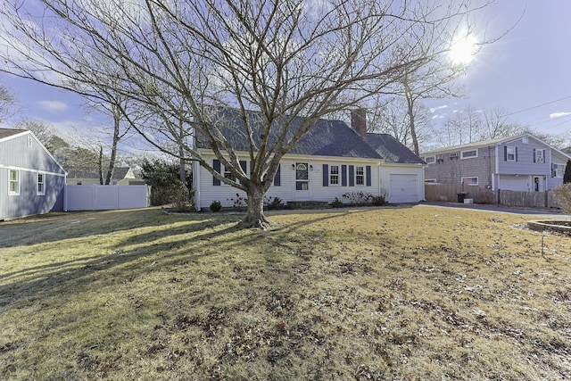 rear view of house featuring a garage and a yard