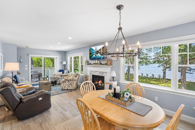 10 Stanley Rd, Mashpee, MA 02649 - dining space with a high end fireplace, light wood-style floors, a chandelier, and recessed lighting