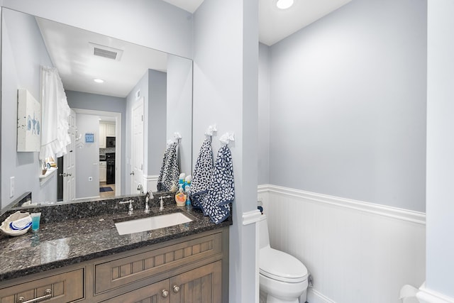 10 Stanley Rd, Mashpee, MA 02649 - bathroom featuring a wainscoted wall, vanity, and a decorative wall