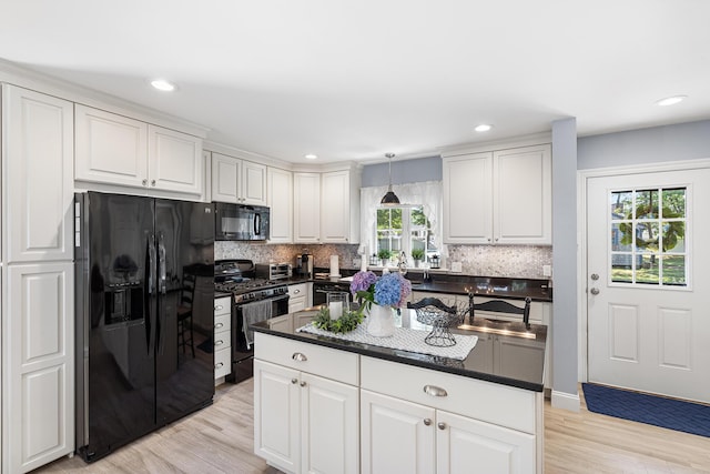 10 Stanley Rd, Mashpee, MA 02649 - kitchen featuring black appliances, dark countertops, white cabinets, light wood-style flooring, and recessed lighting