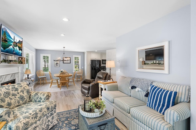 10 Stanley Rd, Mashpee, MA 02649 - living area with a chandelier, light wood-style floors, recessed lighting, and a fireplace
