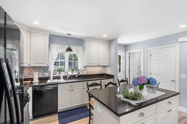 10 Stanley Rd, Mashpee, MA 02649 - kitchen with dishwasher, fridge with ice dispenser, dark countertops, light wood-style flooring, and tasteful backsplash