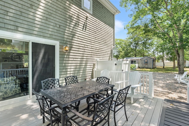 10 Stanley Rd, Mashpee, MA 02649 - wooden terrace with outdoor dining area and a storage shed