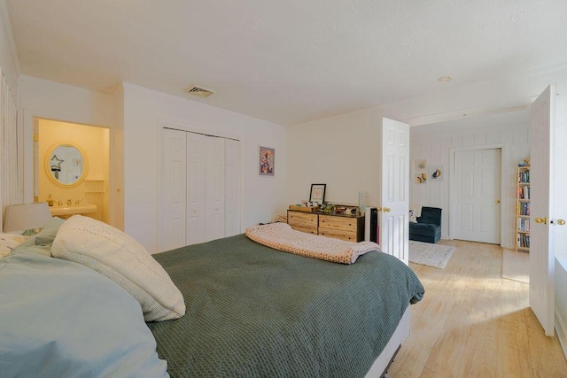 bedroom with a closet and light hardwood / wood-style floors