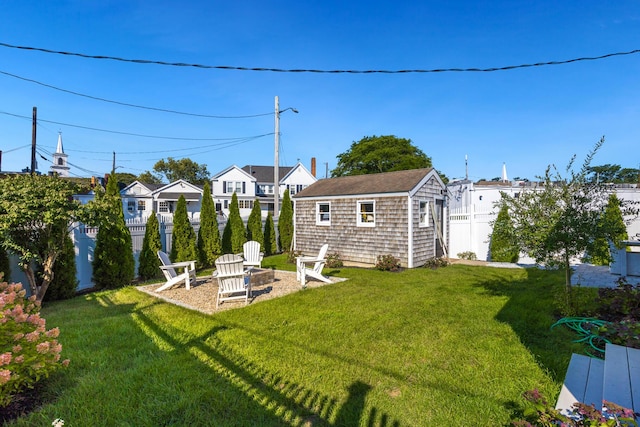 view of yard featuring an outdoor fire pit and an outdoor structure