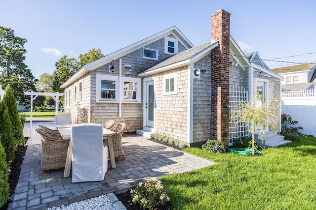 rear view of property with a patio area and a lawn