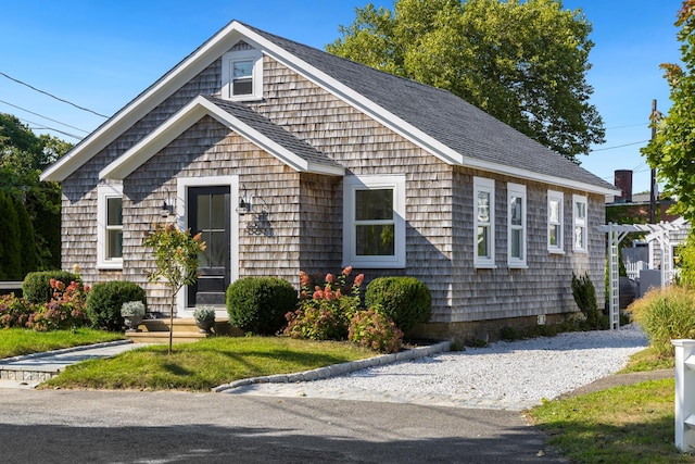 bungalow-style home featuring a front yard