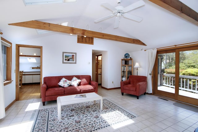 21 High Point Dr, Brewster, MA 02631 - living room with beam ceiling, light tile patterned flooring, a ceiling fan, baseboards, and high vaulted ceiling