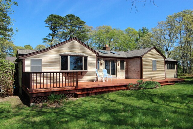 21 High Point Dr, Brewster, MA 02631 - rear view of property featuring a chimney, a lawn, a wooden deck, and solar panels