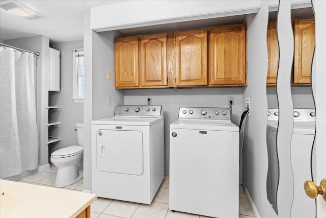 washroom featuring light tile patterned floors, cabinet space, visible vents, and washer and dryer