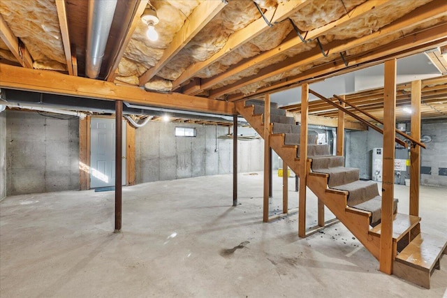 unfinished basement featuring stairs