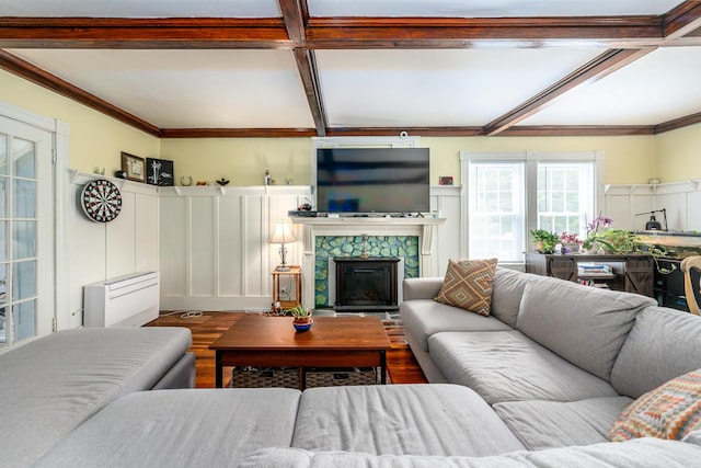 living room with a fireplace, coffered ceiling, light wood-type flooring, and beamed ceiling