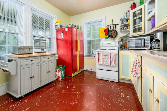 kitchen with white electric range oven and refrigerator